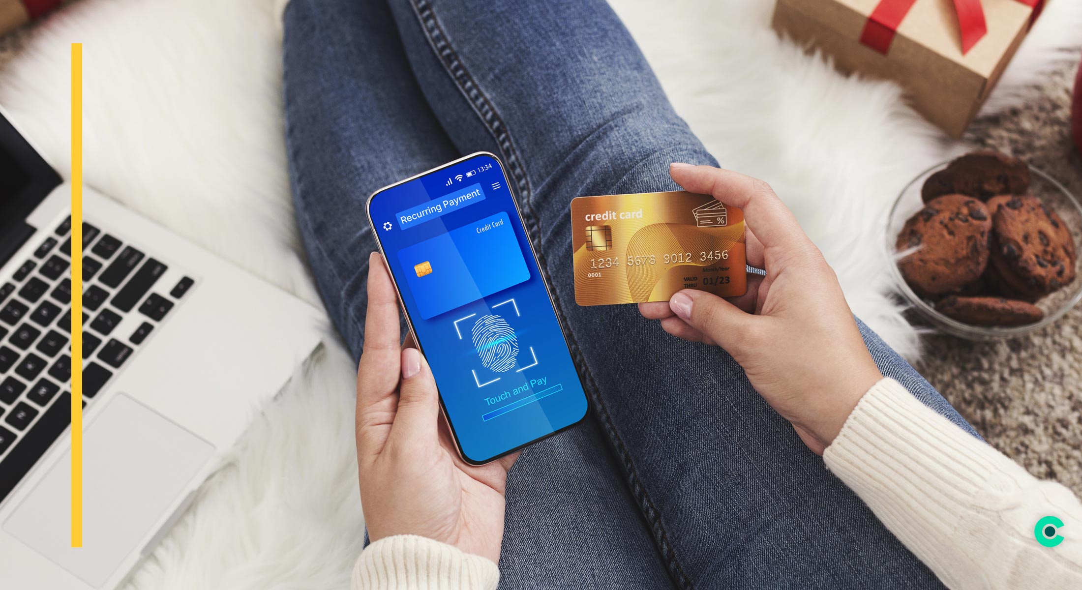 Woman holding credit card and mobile phone, completing setup of recurring payments