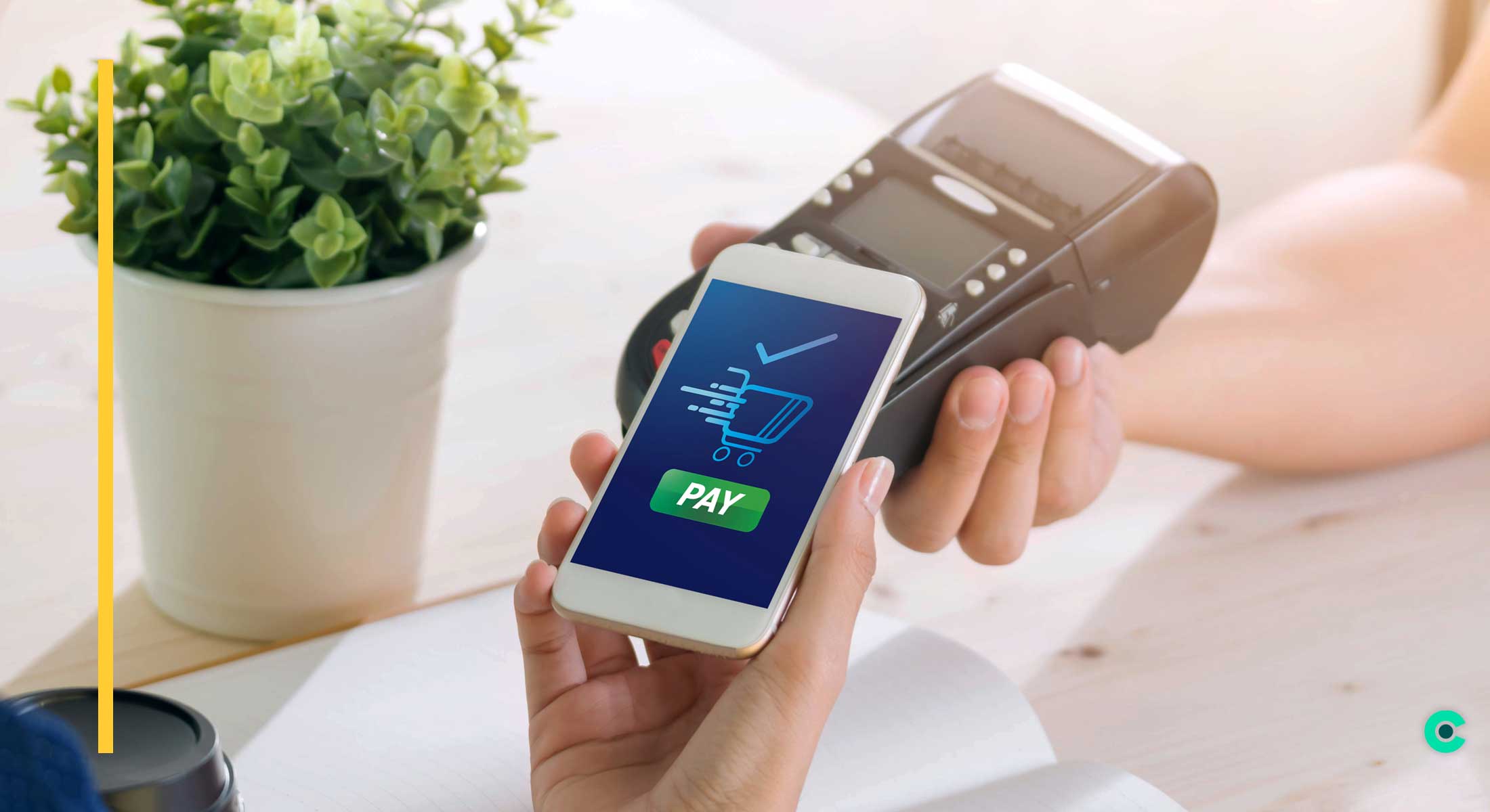 A person pays with their phone at a payment terminal