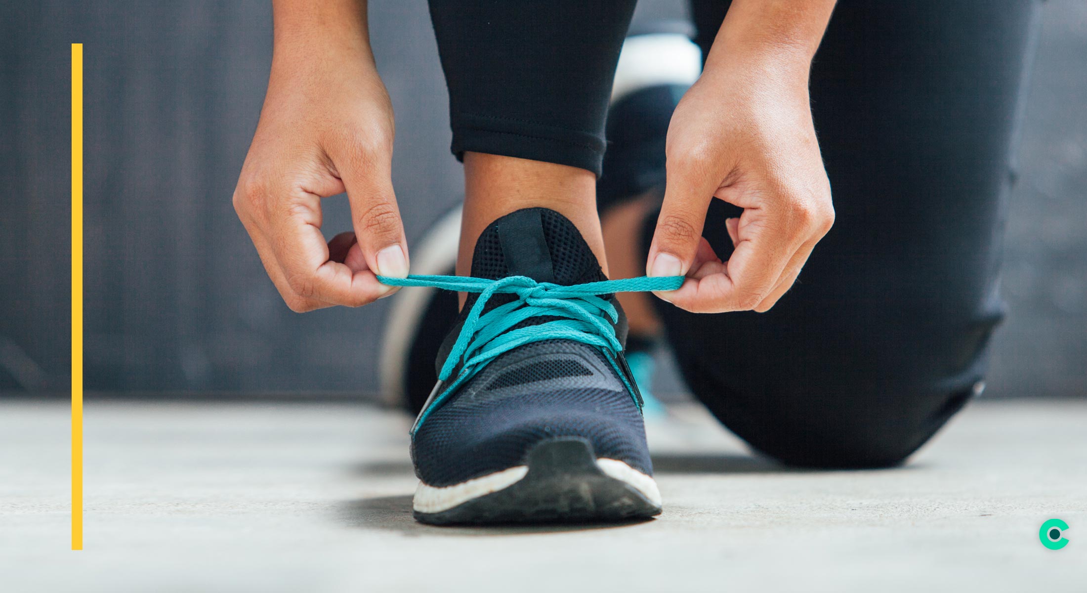 Close up of woman's foot while tying her running shoe
