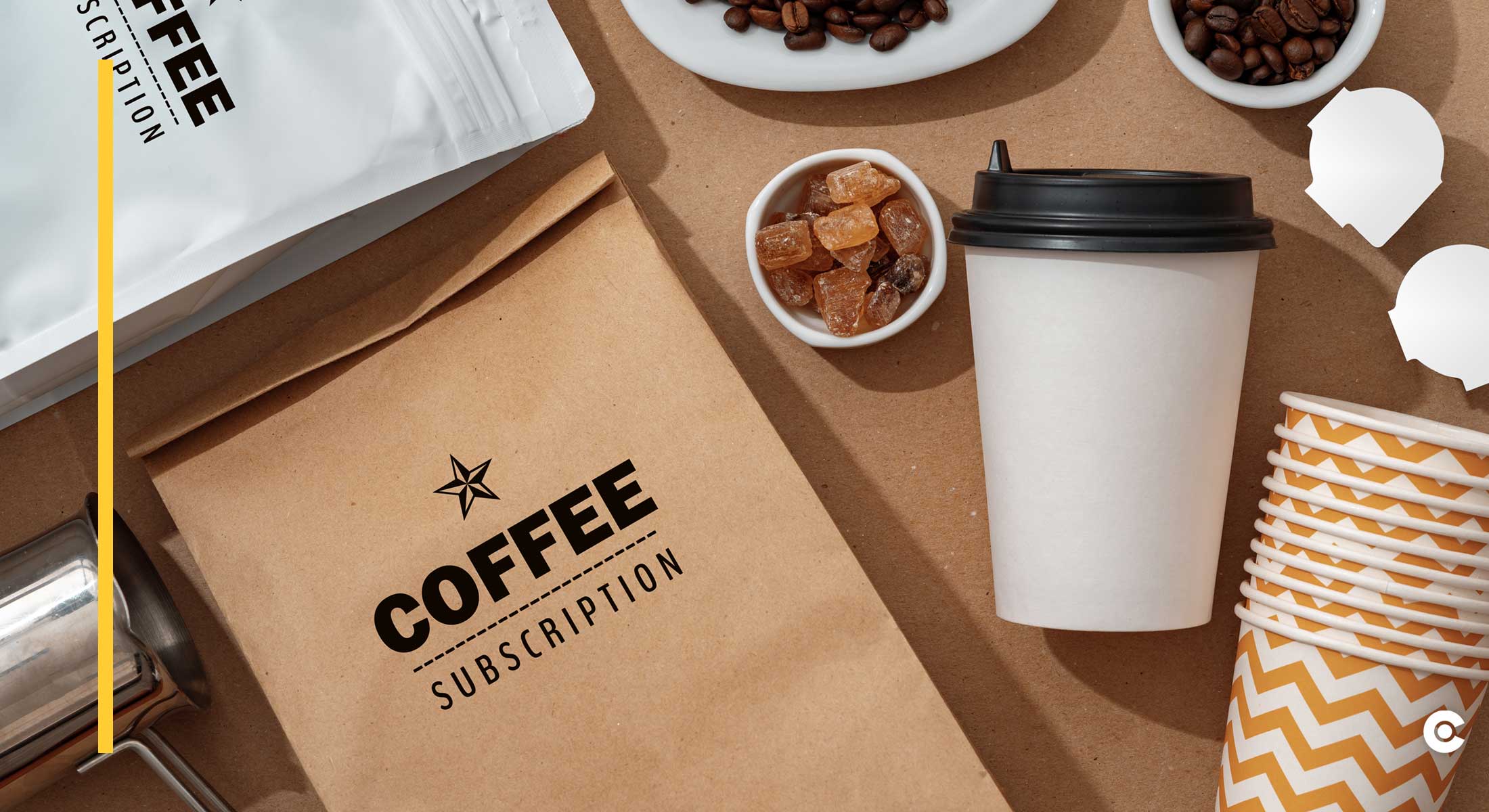 A brown bag with "Coffee Subscription" logo lays on a table with coffee beans.