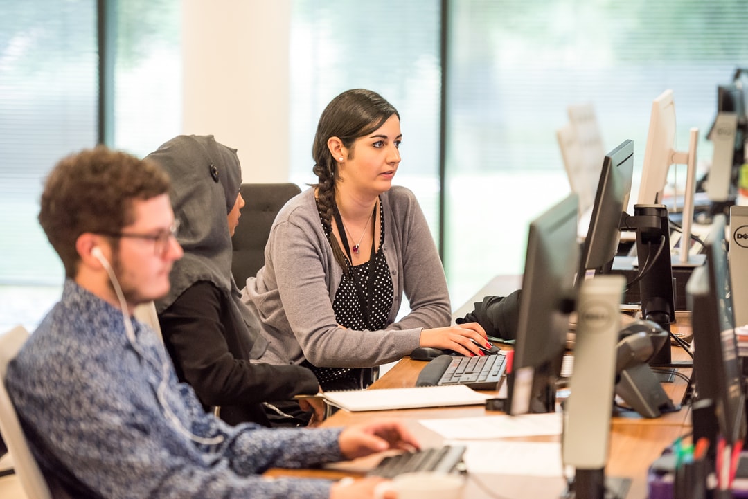 Professionals working at computers in an office.
