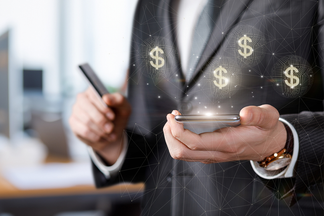 Image of a person with a phone and dollar sigs.